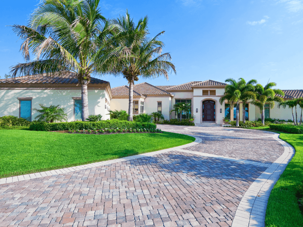Luxury Florida home with palm trees, tile roof, and hurricane-resistant windows